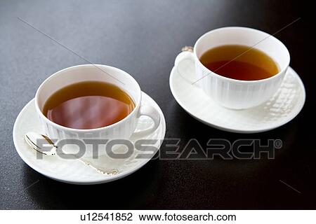 Two cups of tea, high angle view, black background View Large Photo Image Stock Image - Two cups of tea, high angle view, black background. Fotosearch