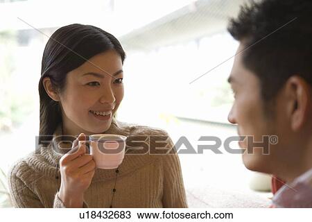 Woman holding a cup and smiling to the man, front view, side view, Japan View Large Photo Image Stock Image - Woman holding a cup and smiling to the man, front view, side view, Japan. Fotosearch