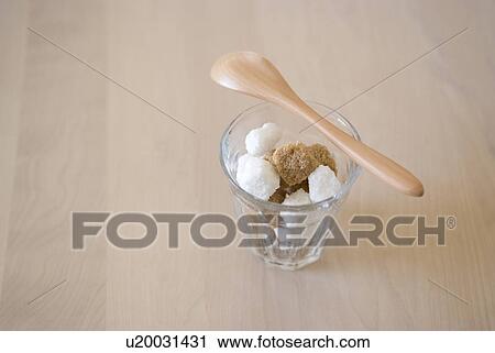 Stock Image - Sugar cubes in glass. Fotosearch