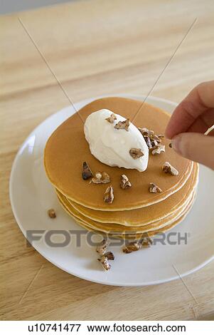 Stock Photo - Woman decorating pancakes. Fotosearch