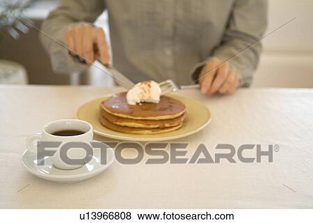Stock Photo - Woman eating pancakes. Fotosearch