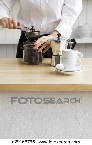 Woman grinding coffee beans View Large Photo Image Stock Photography - Woman grinding coffee beans. Fotosearch