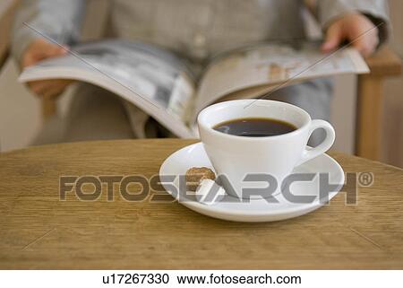 Stock Image - Woman reading magazine. Fotosearch