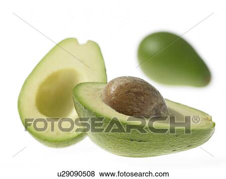 Avocado cut in half with pit View Large Photo Image Stock Photo - Avocado cut in half with pit. Fotosearch