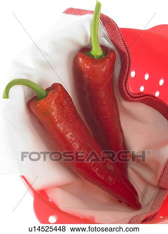Stock Photo - Ramiro Peppers on a cloth in a strainer. Fotosearch
