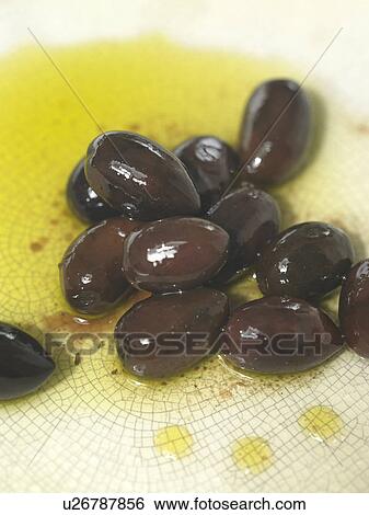 Stock Photograph - Wet Black Olives on a plate. Fotosearch