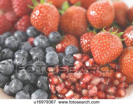 Stock Photo - Blueberries raspberries strawberries and Pomegranate seed. Fotosearch