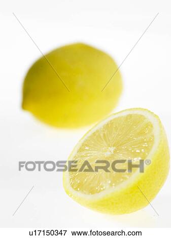 One half Lemon with a whole lemon in background View Large Photo Image Stock Photo - One half Lemon with a whole lemon in background. Fotosearch