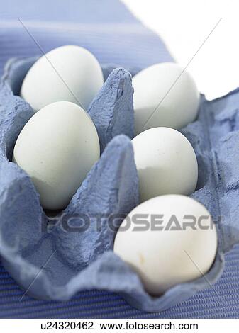 Stock Image - Half carton of eggs with five still inside. Fotosearch