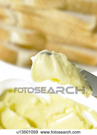 Bread slices and Butter on a knife View Large Photo Image Stock Photo - Bread slices and Butter on a knife. Fotosearch