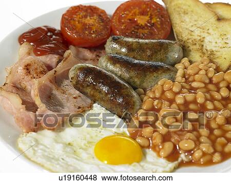 Stock Photo - British Breakfast with Bacon, Eggs, Sausage, Beans and Tomato. Fotosearch