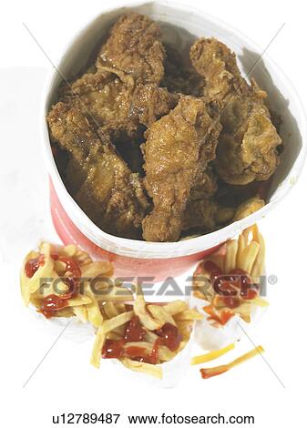 Bucket of fried chicken and French fried chips in take out packaging View Large Photo Image Stock Photo - Bucket of fried chicken and French fried chips in take out packaging. Fotosearch
