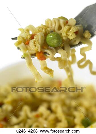 Noodle snack with peas on a fork View Large Photo Image Stock Photo - Noodle snack with peas on a fork. Fotosearch