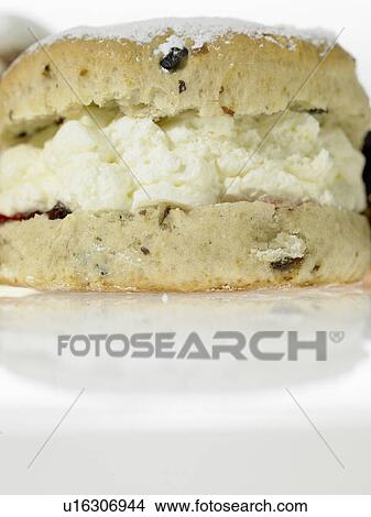 Picture - One scone with cream inside. Fotosearch