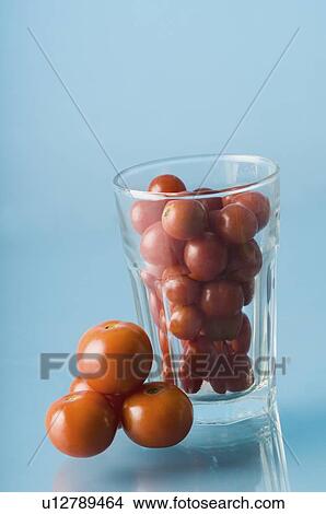 Close-up of a glass full of cherry tomatoes View Large Photo Image Picture - Close-up of a glass full of cherry tomatoes. Fotosearch
