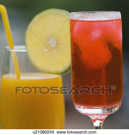Close-up of a glass of cocktail and a glass of juice View Large Photo Image Picture - Close-up of a glass of cocktail and a glass of juice. Fotosearch