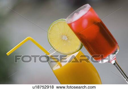 Close-up of a glass of cocktail and a glass of juice View Large Photo Image Stock Photo - Close-up of a glass of cocktail and a glass of juice. Fotosearch