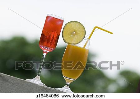 Stock Photograph - Close-up of a glass of cocktail and a glass of juice. Fotosearch