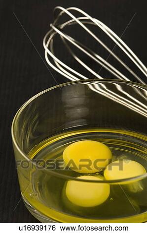 Close-up of egg yolks in a glass bowl with an egg beater View Large Photo Image Stock Photograph - Close-up of egg yolks in a glass bowl with an egg beater. Fotosearch