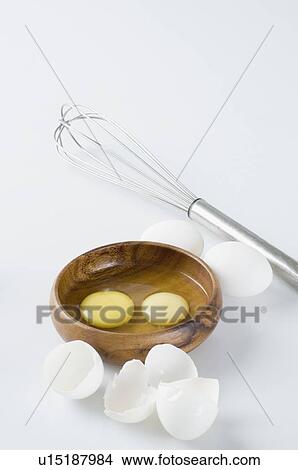 Picture - Close-up of egg yolks in a wooden bowl. Fotosearch