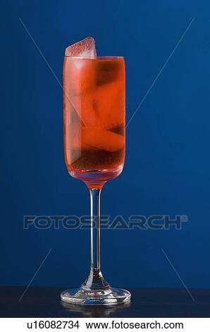 Picture - Close-up of ice cubes in a glass of cocktail. Fotosearch