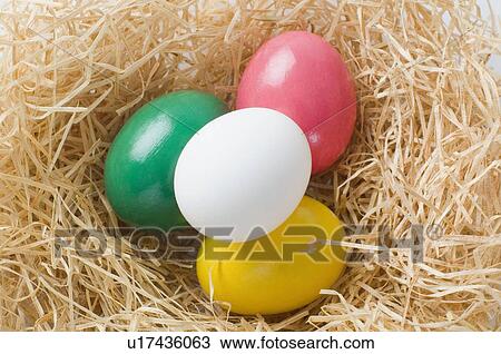 Stock Image - High angle view of Easter eggs in a bird's nest. Fotosearch