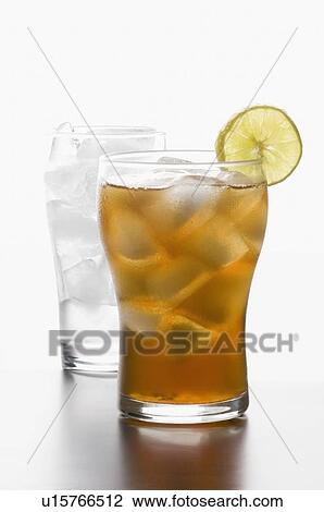 Stock Image - Close-up of a glass of lemonade with ice cubes and a slice of lemon. Fotosearch