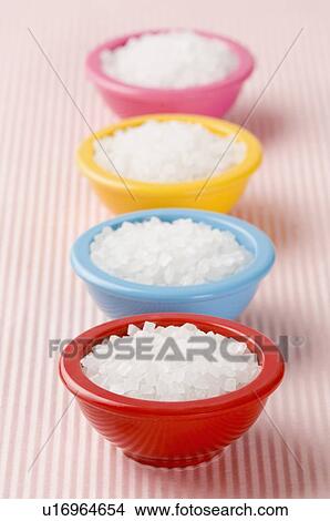 Picture - Close-up of a row of four bowls filled with sugar candies. Fotosearch