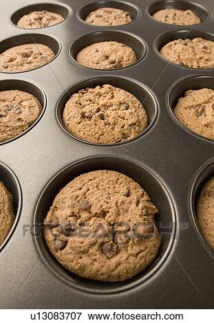 Stock Photo - Close-up of brown biscuits in a baking tray. Fotosearch