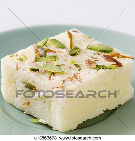 Stock Photo - Close-up of Burfi garnished with Almond and Pistachio. Fotosearch