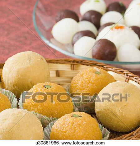 Close-up of Ladoos in a basket View Large Photo Image Stock Photograph - Close-up of Ladoos in a basket. Fotosearch