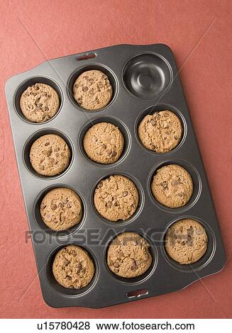 Stock Photo - High angle view of brown biscuits in a baking tray. Fotosearch