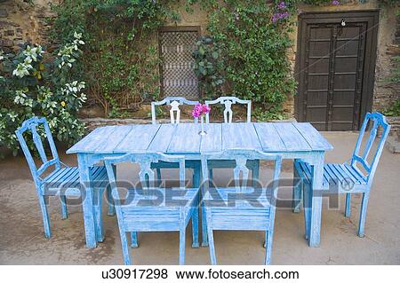Dining table and chairs out side a house View Large Photo Image Stock Photo - Dining table and chairs out side a house. Fotosearch