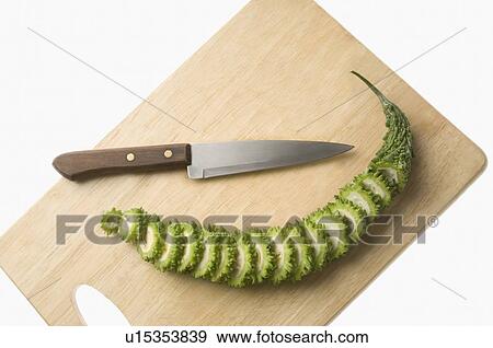 Close-up of a knife with slices of bitter melon on a cutting board View Large Photo Image Stock Photo - Close-up of a knife with slices of bitter melon on a cutting board. Fotosearch