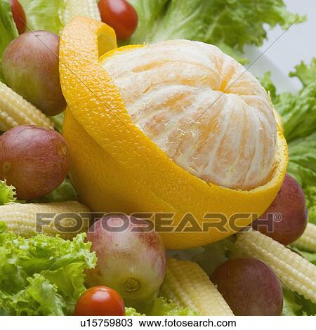Close-up of a peeled orange with baby corns and cherry tomatoes View Large Photo Image Stock Image - Close-up of a peeled orange with baby corns and cherry tomatoes. Fotosearch