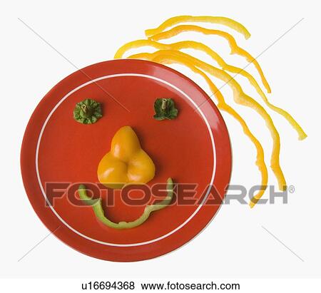Stock Photo - Close-up of bell pepper slices representing a human face. Fotosearch