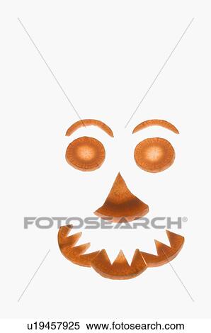 Stock Photography - Close-up of carrot slices arranged in a shape of smiley face. Fotosearch