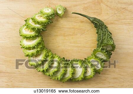 Close-up of slices of bitter melon on a cutting board View Large Photo Image Stock Photography - Close-up of slices of bitter melon on a cutting board. Fotosearch