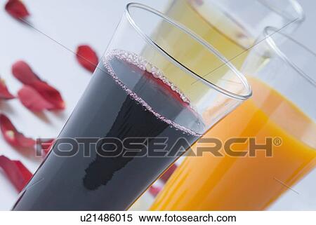 Stock Photography - Close-up of three glasses full of liquid. Fotosearch