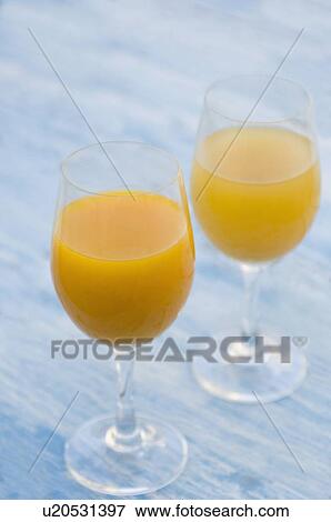 Close-up of two glasses of mango shake View Large Photo Image Stock Photo - Close-up of two glasses of mango shake. Fotosearch