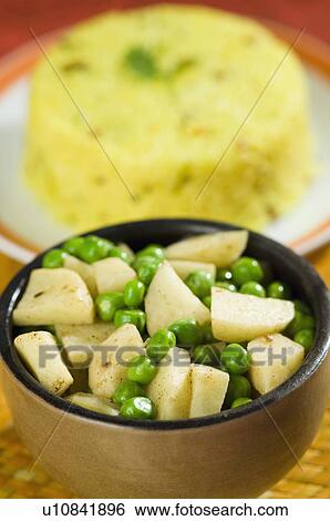 Close-up of a bowl of fried green peas and potatoes View Large Photo Image Stock Photograph - Close-up of a bowl of fried green peas and potatoes. Fotosearch
