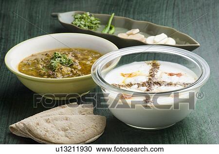 Close-up of a bowl of raita with a bowl of curry and roti View Large Photo Image Stock Image - Close-up of a bowl of raita with a bowl of curry and roti. Fotosearch