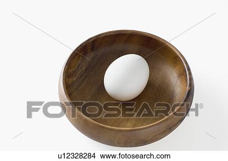 Close-up of an egg in a wooden bowl View Large Photo Image Picture - Close-up of an egg in a wooden bowl. Fotosearch