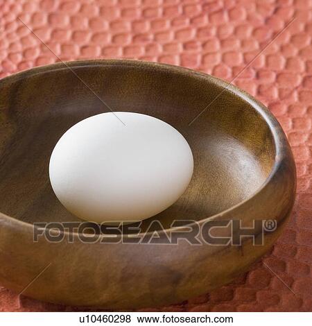 Close-up of an egg in a wooden bowl View Large Photo Image Stock Photo - Close-up of an egg in a wooden bowl. Fotosearch