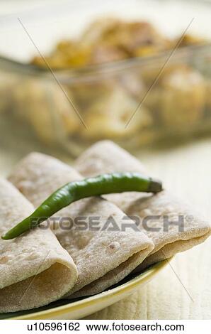 Stock Image - Close-up of chapattis in a plate. Fotosearch
