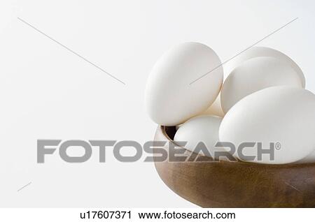 Close-up of eggs in a wooden bowl View Large Photo Image Stock Image - Close-up of eggs in a wooden bowl. Fotosearch