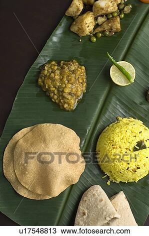 Stock Image - Close-up of Indian food on a banana leaf. Fotosearch