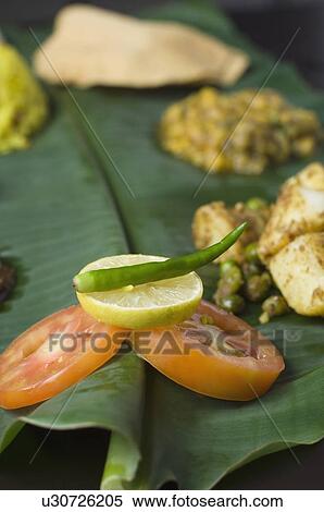 Stock Photography - Close-up of Indian food on a banana leaf. Fotosearch