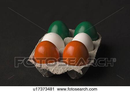 Stock Image - Close-up of six eggs painted in colors of Indian flag. Fotosearch