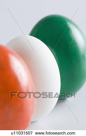 Stock Photo - Close-up of three eggs painted in colors of Indian flag. Fotosearch